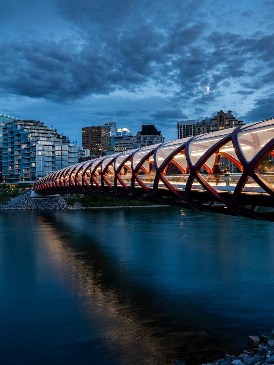 Downtown Calgary skyline at night with the Peace Bridge in the foreground